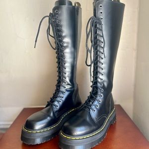 Dr. Martens black knee-high platform boots.